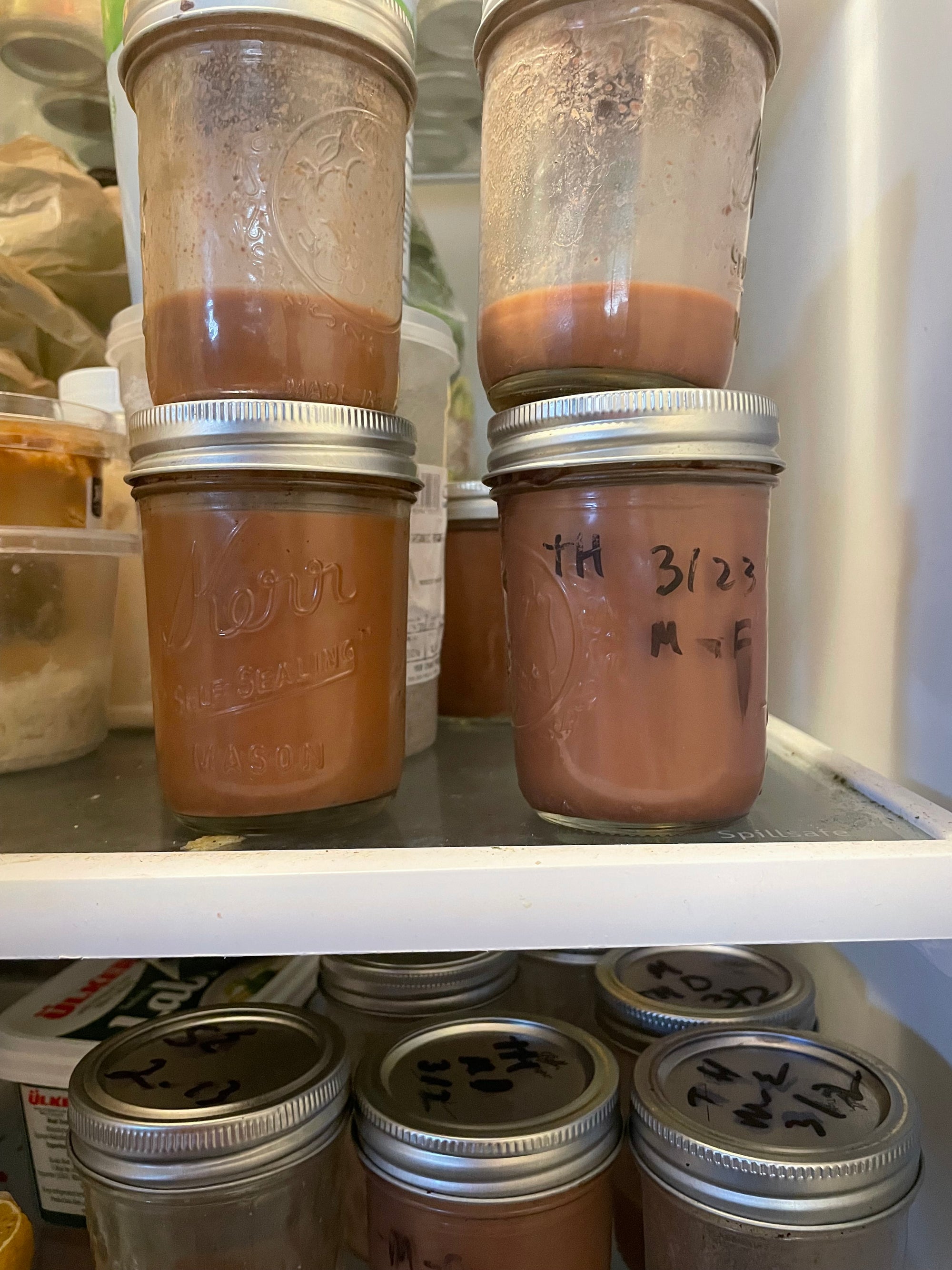 Samples of pecan milk in a fridge
